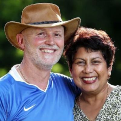 Giorgos Kyrgios is wearing a hat as he and Norlaila Kyrgios are smiling for the camera.